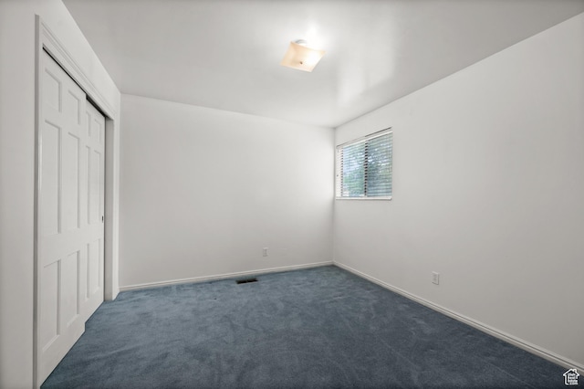 2220 E Murray Holladay Rd Unit 184, Holladay, UT 84117 - unfurnished bedroom featuring dark colored carpet, a closet, and baseboards