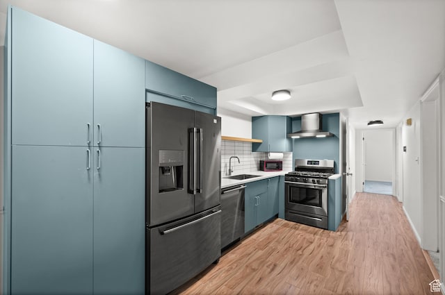 2220 E Murray Holladay Rd Unit 184, Holladay, UT 84117 - kitchen with appliances with stainless steel finishes, wall chimney exhaust hood, a sink, light wood-type flooring, and open shelves
