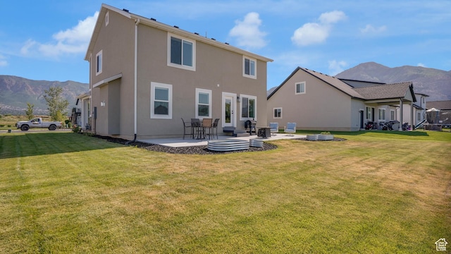 101 E 1500 N, North Ogden, UT 84404 - back of house with a mountain view, a patio area, a lawn, and stucco siding