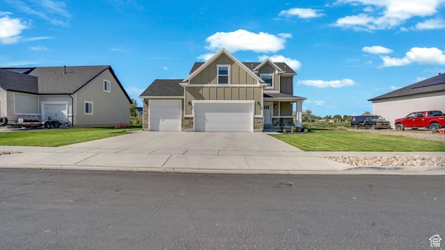 101 E 1500 N, North Ogden, UT 84404 - craftsman house featuring board and batten siding, a front lawn, concrete driveway, a garage, and stone siding