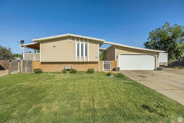 953 E 100 S, Layton, UT 84041 - view of front of home featuring driveway, a garage, and brick siding