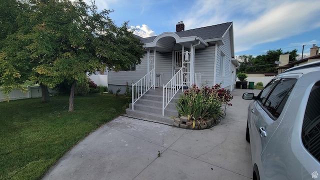 902 W 500 N, Provo, UT 84601 - view of front facade featuring a chimney, a front yard, and roof with shingles