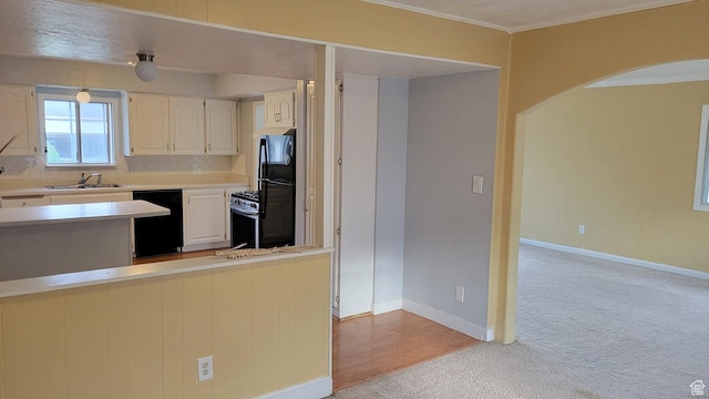 902 W 500 N, Provo, UT 84601 - kitchen with black appliances, a sink, light colored carpet, arched walkways, and decorative backsplash