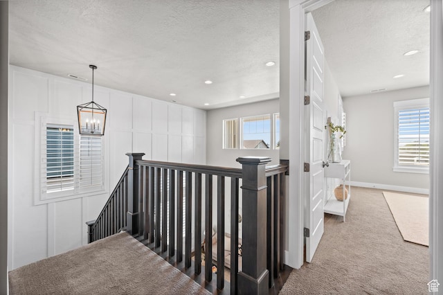 10685 S Dielsdorf Rd E, Sandy, UT 84092 - stairs with carpet, a textured ceiling, a chandelier, recessed lighting, and baseboards