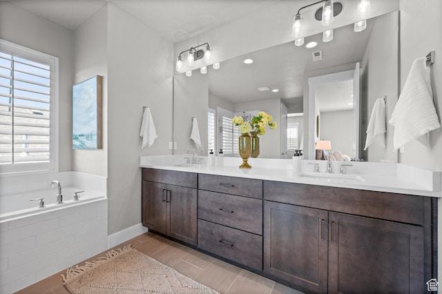 10685 S Dielsdorf Rd E, Sandy, UT 84092 - ensuite bathroom featuring double vanity, a garden tub, healthy amount of natural light, and wood finished floors