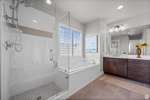 10685 S Dielsdorf Rd E, Sandy, UT 84092 - bathroom with vanity, a garden tub, a stall shower, and recessed lighting