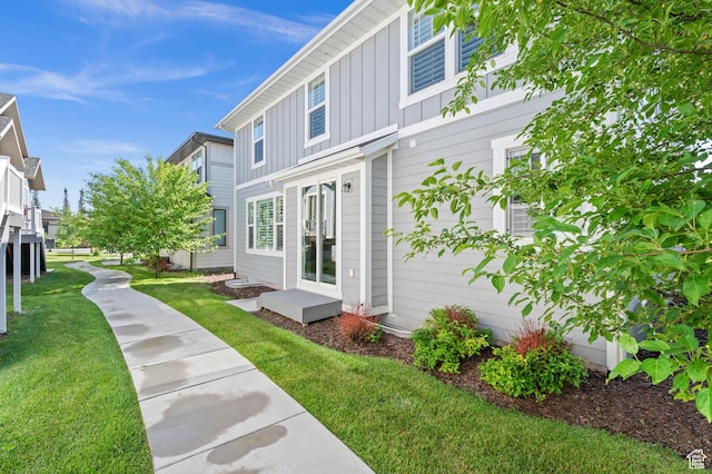 10685 S Dielsdorf Rd E, Sandy, UT 84092 - view of side of home featuring board and batten siding and a yard