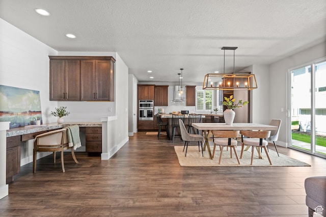 10685 S Dielsdorf Rd E, Sandy, UT 84092 - dining space featuring dark wood-type flooring, a textured ceiling, recessed lighting, and baseboards