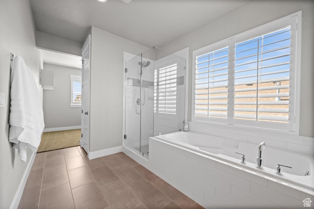 10685 S Dielsdorf Rd E, Sandy, UT 84092 - full bathroom with a bath, a shower stall, baseboards, and tile patterned floors