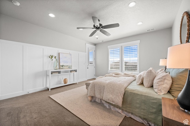 10685 S Dielsdorf Rd E, Sandy, UT 84092 - carpeted bedroom featuring a textured ceiling, ceiling fan, recessed lighting, and a decorative wall
