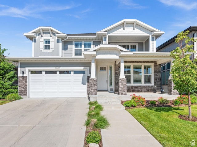 10685 S Dielsdorf Rd E, Sandy, UT 84092 - view of front facade with driveway, stone siding, an attached garage, and a front yard