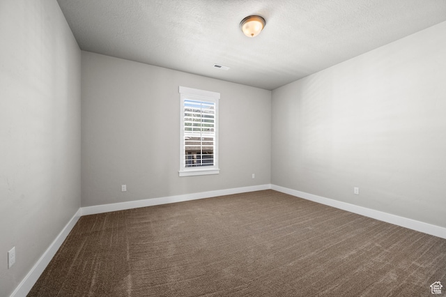 10685 S Dielsdorf Rd E, Sandy, UT 84092 - spare room with dark colored carpet, a textured ceiling, and baseboards