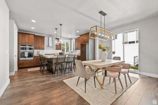 10685 S Dielsdorf Rd E, Sandy, UT 84092 - dining space with recessed lighting, baseboards, light wood-type flooring, and a textured ceiling