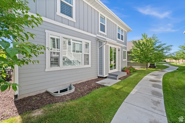 10685 S Dielsdorf Rd E, Sandy, UT 84092 - view of side of home with board and batten siding and a yard