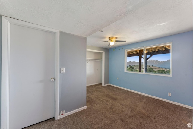 8043 W Hi Country Rd S, Herriman, UT 84096 - unfurnished bedroom with carpet flooring, a textured ceiling, baseboards, a closet, and ceiling fan
