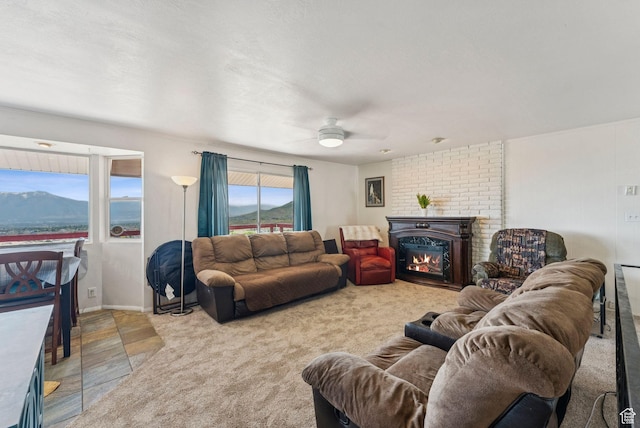 8043 W Hi Country Rd S, Herriman, UT 84096 - living area with a glass covered fireplace, a ceiling fan, and a mountain view
