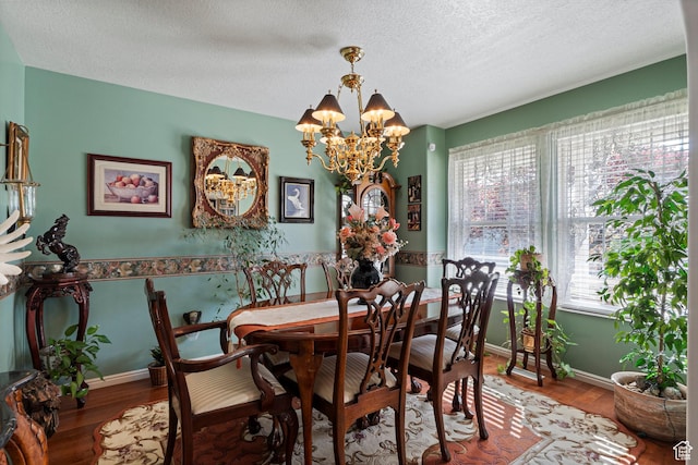 963 E 1275 N, Ogden, UT 84404 - dining space with a chandelier, wood finished floors, a textured ceiling, and baseboards