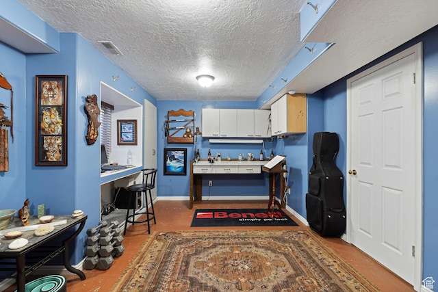 963 E 1275 N, Ogden, UT 84404 - kitchen with a textured ceiling, white cabinets, baseboards, and an office area