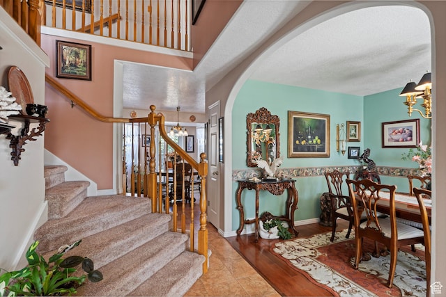 963 E 1275 N, Ogden, UT 84404 - foyer with a chandelier, arched walkways, stairway, wood finished floors, and baseboards