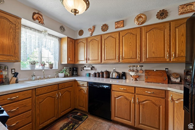 963 E 1275 N, Ogden, UT 84404 - kitchen with black dishwasher, a sink, brown cabinets, light countertops, and a textured ceiling