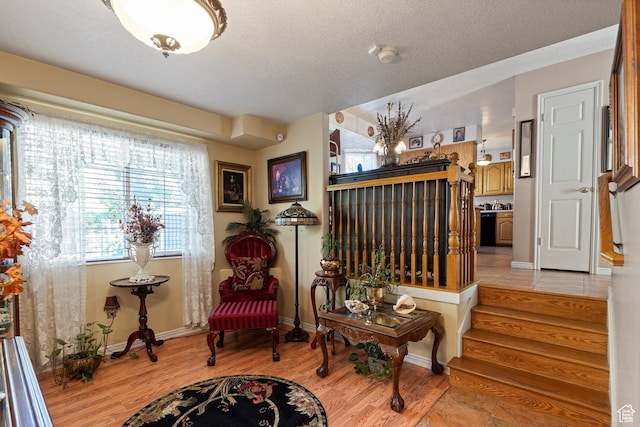 963 E 1275 N, Ogden, UT 84404 - sitting room featuring light wood-type flooring, baseboards, a textured ceiling, and stairs