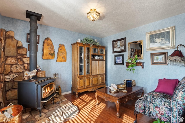 963 E 1275 N, Ogden, UT 84404 - living room with a wood stove, hardwood / wood-style floors, a textured ceiling, and baseboards