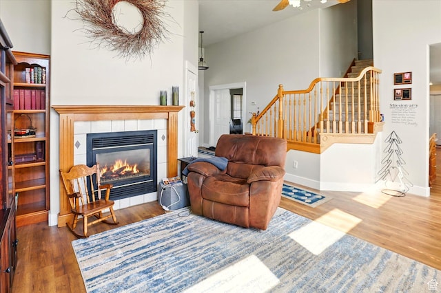 913 N 2300 W, Tremonton, UT 84337 - living area with stairs, wood finished floors, a tile fireplace, ceiling fan, and baseboards