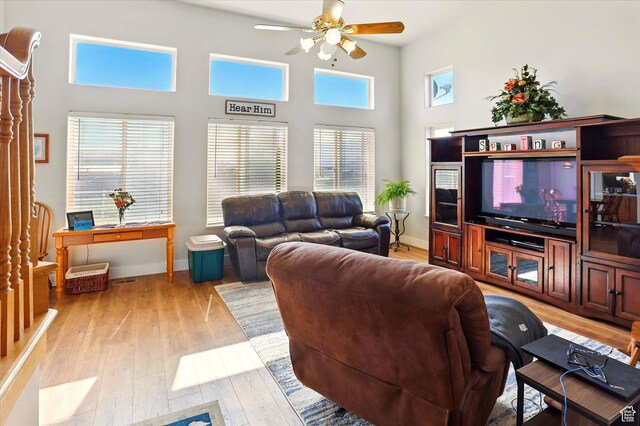 913 N 2300 W, Tremonton, UT 84337 - living room featuring ceiling fan, light wood-style floors, baseboards, and a towering ceiling