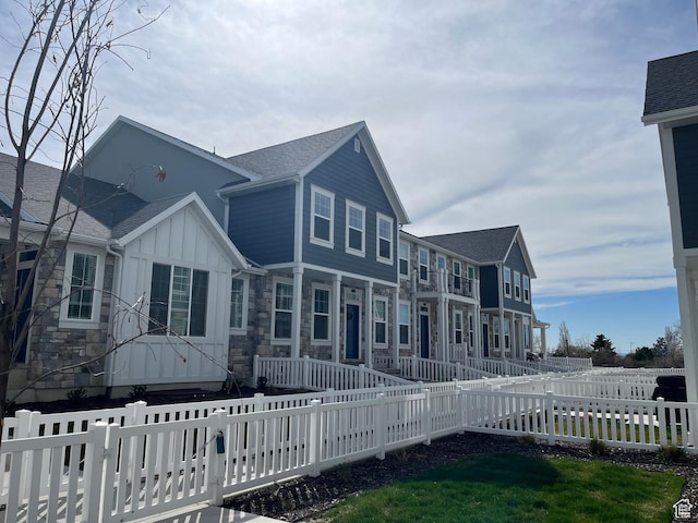 520 S Orchard Dr Unit 17, Bountiful, UT 84010 - view of front of property featuring a fenced front yard, roof with shingles, and board and batten siding