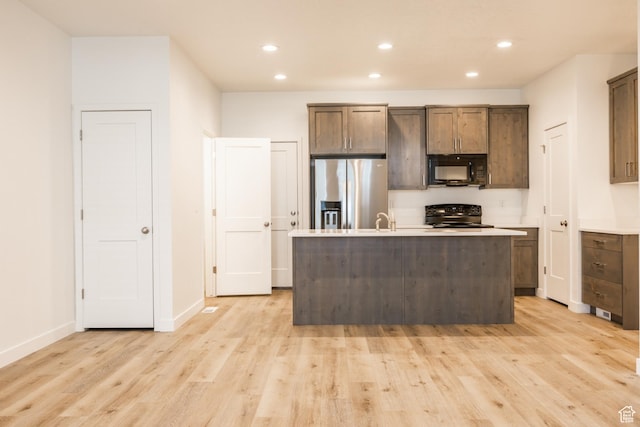 520 S Orchard Dr Unit 17, Bountiful, UT 84010 - kitchen featuring stainless steel fridge with ice dispenser, black microwave, range, recessed lighting, and light wood finished floors