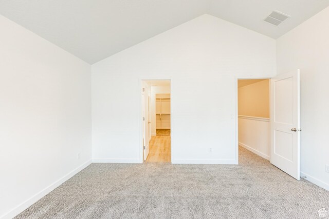 520 S Orchard Dr Unit 17, Bountiful, UT 84010 - unfurnished bedroom with lofted ceiling, a spacious closet, light carpet, and baseboards