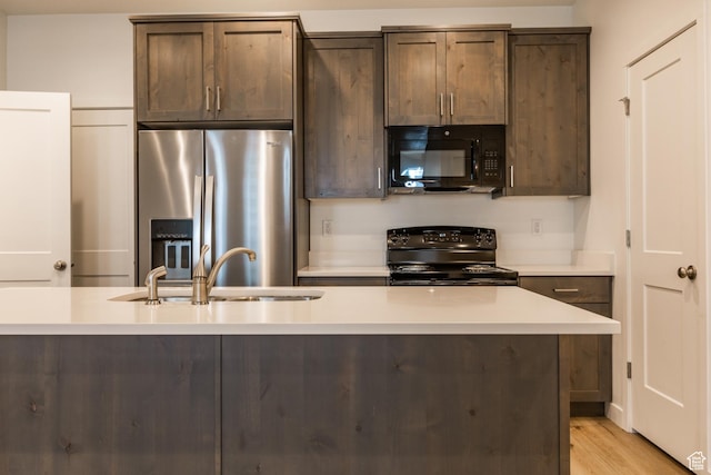 520 S Orchard Dr Unit 17, Bountiful, UT 84010 - kitchen featuring black appliances, light countertops, dark brown cabinetry, and a sink