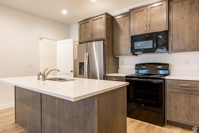 520 S Orchard Dr Unit 17, Bountiful, UT 84010 - kitchen with black appliances, a sink, light wood-type flooring, light countertops, and recessed lighting