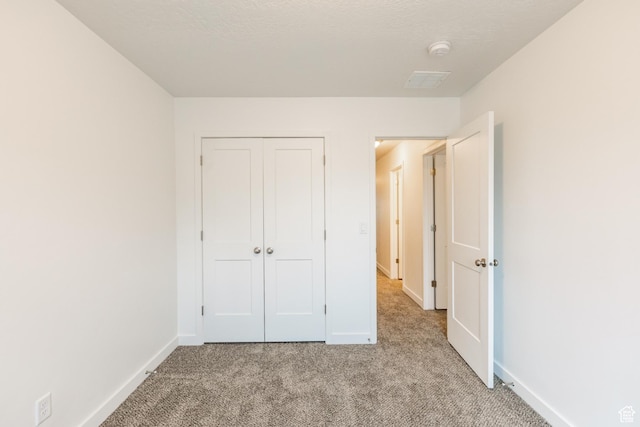 520 S Orchard Dr Unit 17, Bountiful, UT 84010 - unfurnished bedroom with light carpet, baseboards, and a closet