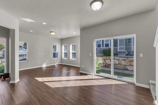 4957 N Marble Fox Way E Unit 118, Lehi, UT 84043 - unfurnished living room with dark wood-style floors, healthy amount of natural light, baseboards, and recessed lighting