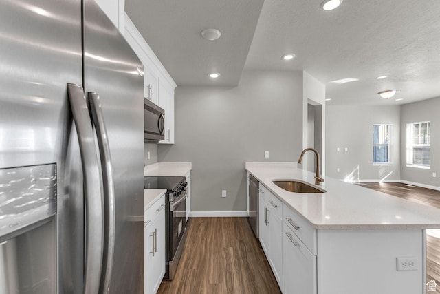 4957 N Marble Fox Way E Unit 118, Lehi, UT 84043 - kitchen with appliances with stainless steel finishes, a sink, a peninsula, baseboards, and dark wood-type flooring