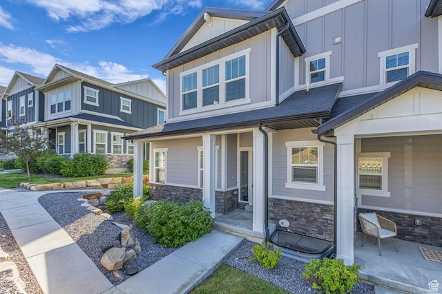 4957 N Marble Fox Way E Unit 118, Lehi, UT 84043 - view of front of house featuring board and batten siding, stone siding, and covered porch