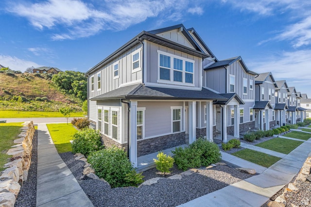 4957 N Marble Fox Way E Unit 118, Lehi, UT 84043 - view of home's exterior with board and batten siding, stone siding, a residential view, and a shingled roof
