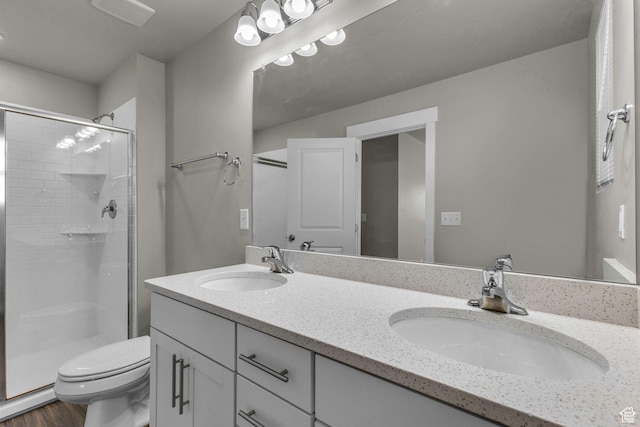 4957 N Marble Fox Way E Unit 118, Lehi, UT 84043 - full bathroom featuring toilet, a stall shower, double vanity, and wood finished floors