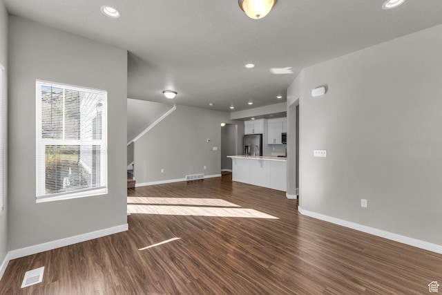 4957 N Marble Fox Way E Unit 118, Lehi, UT 84043 - unfurnished living room with dark wood-style floors, baseboards, recessed lighting, and stairs