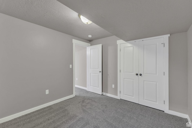 4957 N Marble Fox Way E Unit 118, Lehi, UT 84043 - unfurnished bedroom with carpet flooring, baseboards, a closet, and a textured ceiling