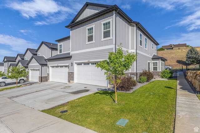 4957 N Marble Fox Way E Unit 118, Lehi, UT 84043 - view of side of home with stone siding, board and batten siding, a garage, and a yard