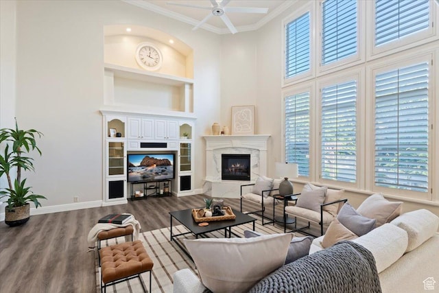 1784 E Ellerbeck Ln, Draper, UT 84020 - living area featuring built in shelves, ornamental molding, baseboards, wood finished floors, and ceiling fan