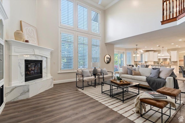 1784 E Ellerbeck Ln, Draper, UT 84020 - living room featuring a fireplace, a high ceiling, ornamental molding, wood finished floors, and baseboards