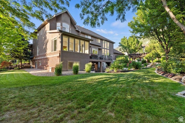 1784 E Ellerbeck Ln, Draper, UT 84020 - back of house with stucco siding, a yard, and brick siding