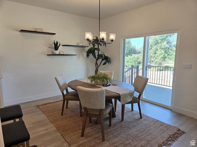 4286 W 1600 S Unit 301, Ogden, UT 84404 - dining space featuring a chandelier and wood finished floors