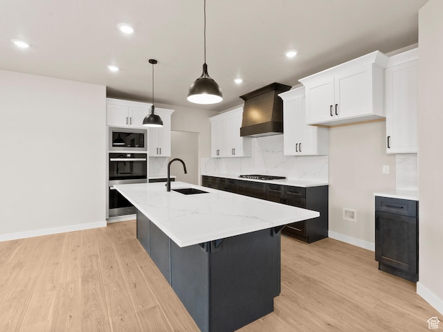 1597 N Cozy Ln Unit 14, Saratoga Springs, UT 84045 - kitchen featuring custom exhaust hood, appliances with stainless steel finishes, an island with sink, light wood-style floors, and recessed lighting