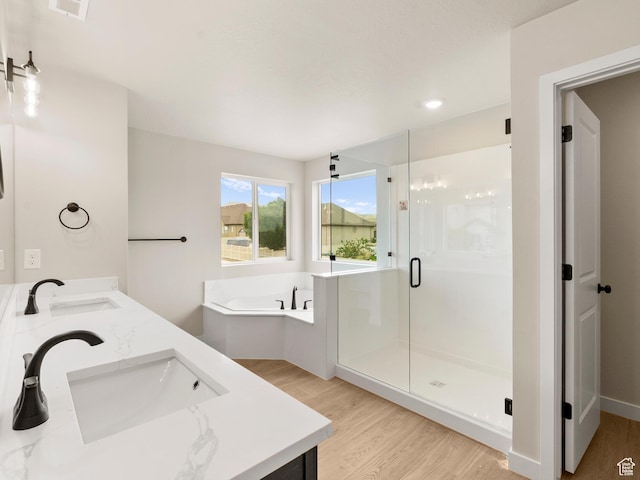 1597 N Cozy Ln Unit 14, Saratoga Springs, UT 84045 - bathroom with wood finished floors, double vanity, a garden tub, a stall shower, and recessed lighting