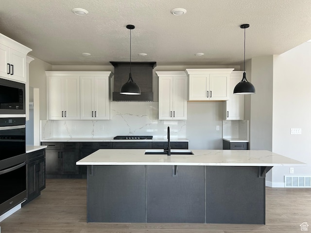 1597 N Cozy Ln Unit 14, Saratoga Springs, UT 84045 - kitchen with a sink, black appliances, custom exhaust hood, light wood finished floors, and backsplash