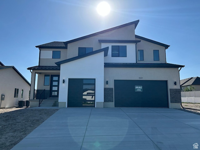 1597 N Cozy Ln Unit 14, Saratoga Springs, UT 84045 - contemporary home with driveway, an attached garage, stucco siding, and a standing seam roof